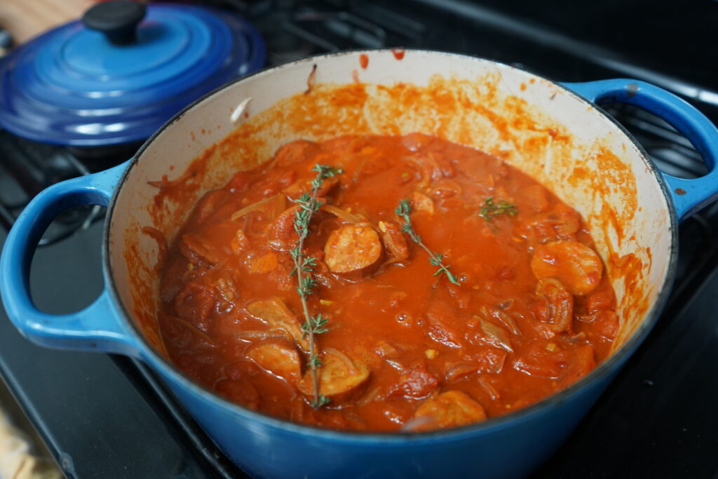 Fresh thyme added to a pot of rougail 