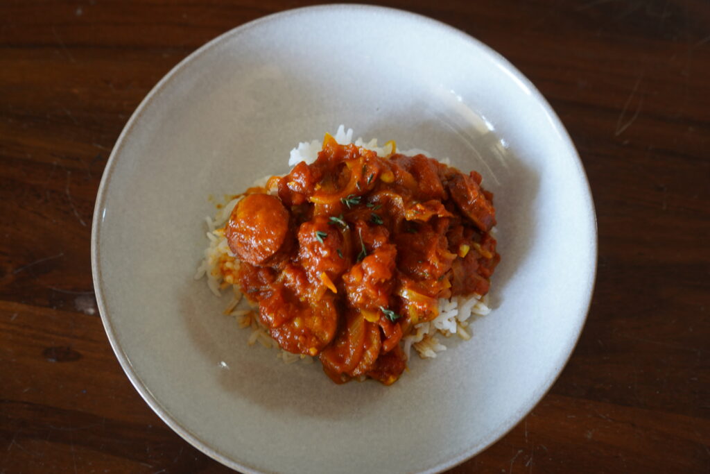 rougail sausage dish on a white plate