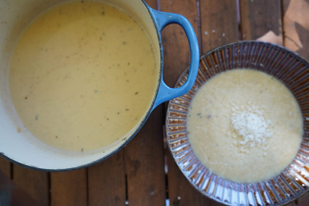 garlic soup in a pot and in a bowl
