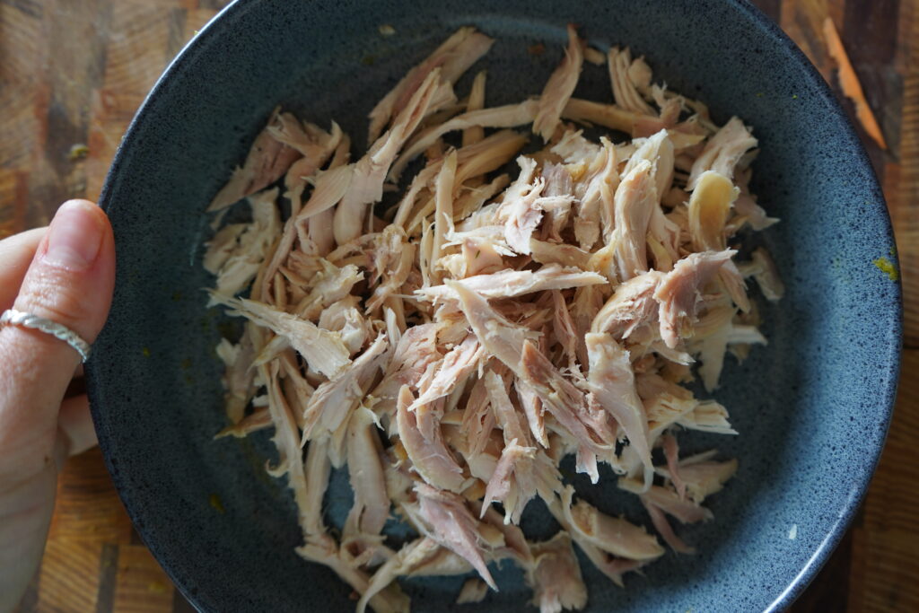 shredded chicken in a blue bowl