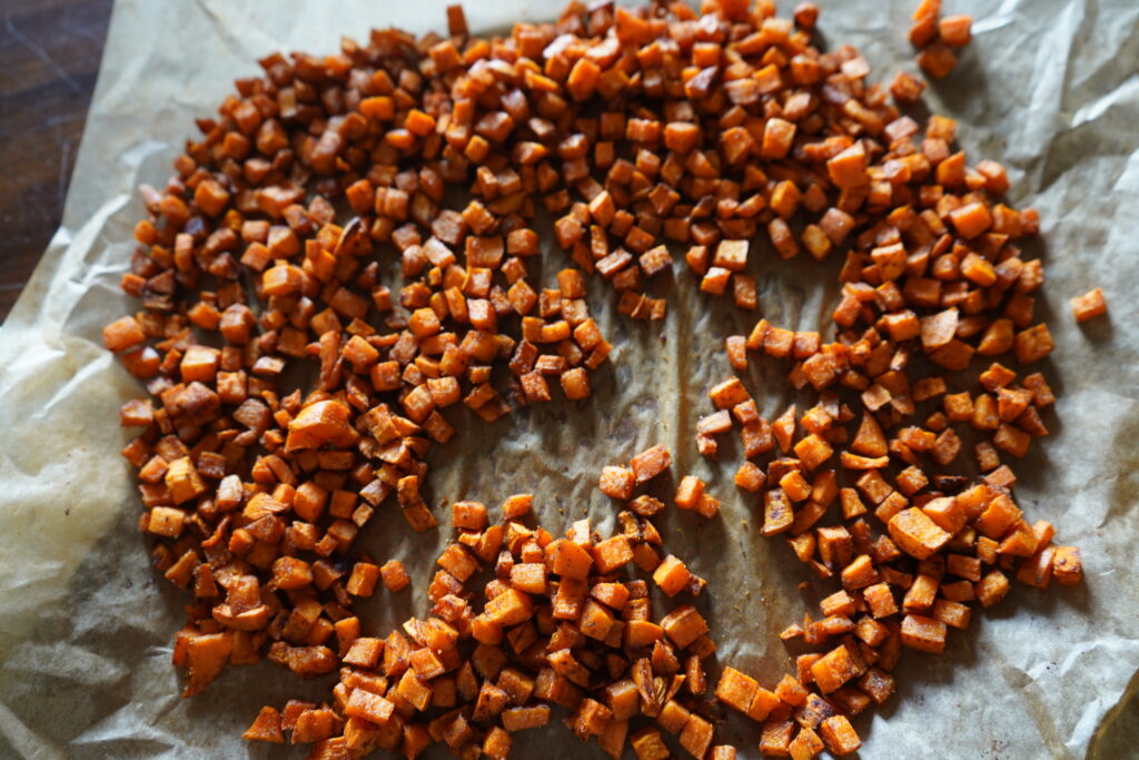 baked sweet potato on a parchment lined dish