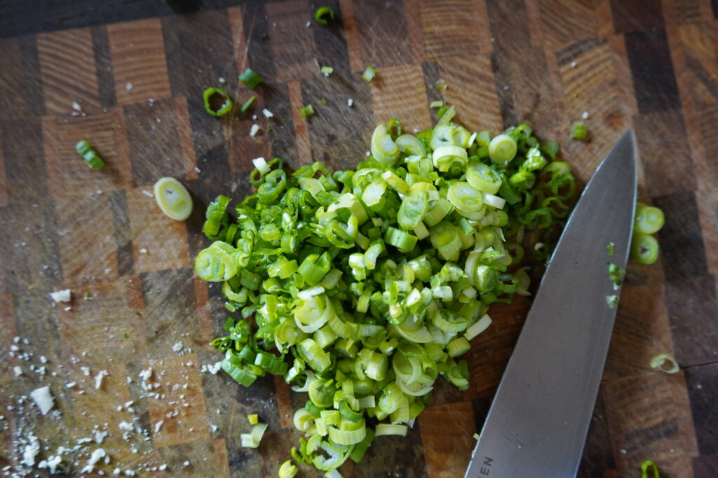 chopped green onion on a cutting board