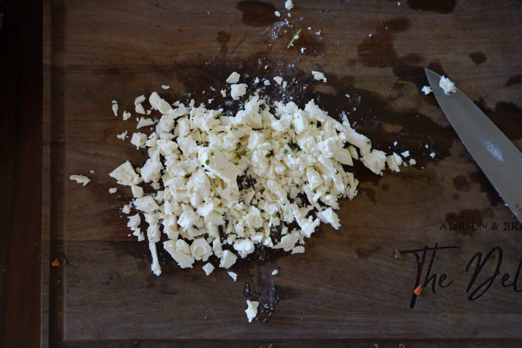 chopped feta cheese on a cutting board