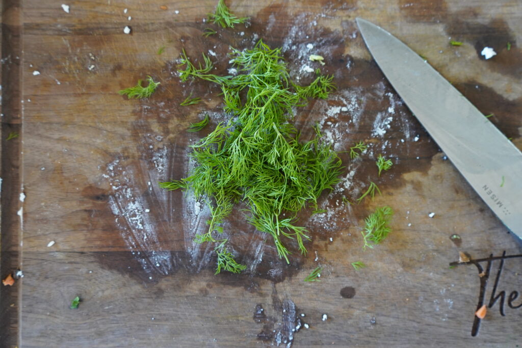 chopped dill on a cutting board