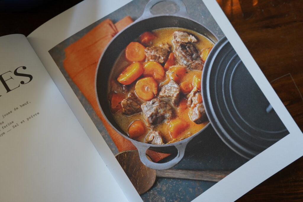 a cookbook with a beef and carrot stew on it