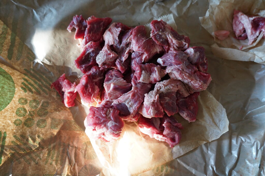 a bunch of beef chunks of parchment paper