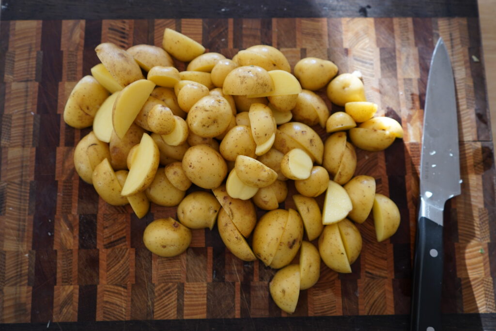 potatoes chopped in half on a cutting board