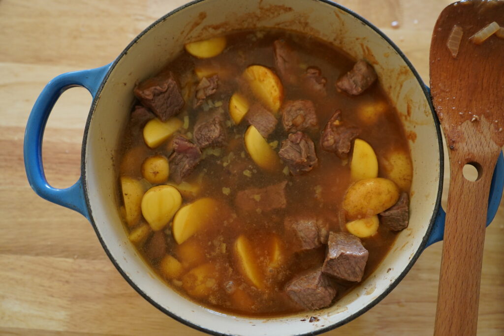 bone broth ebing added to the pot of potatoes and beef