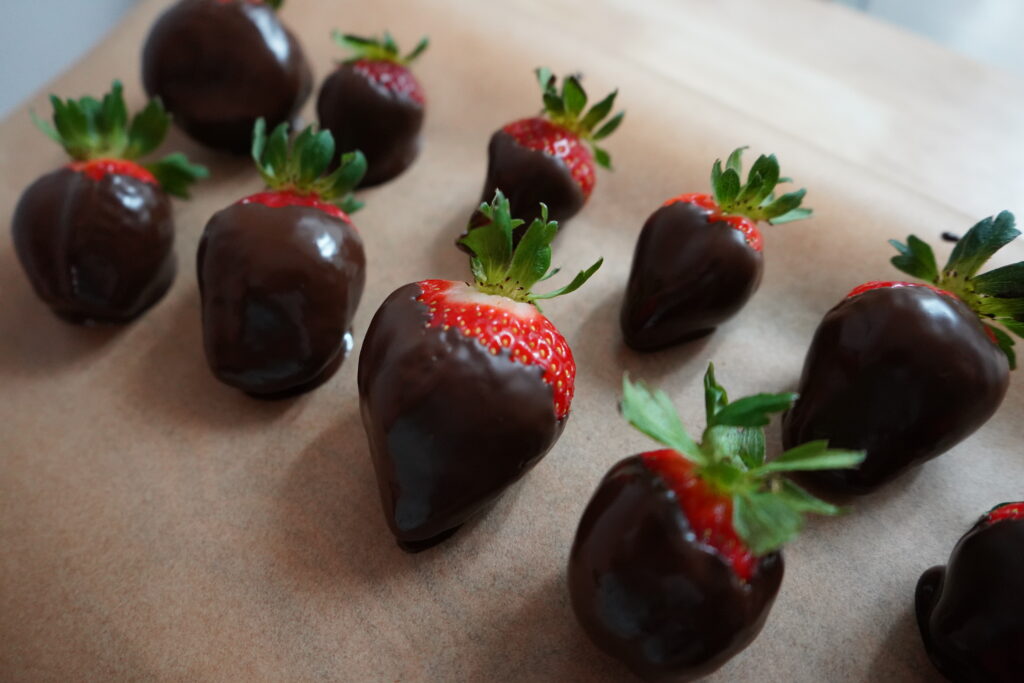 strawberries on a plate with chocolate covering them