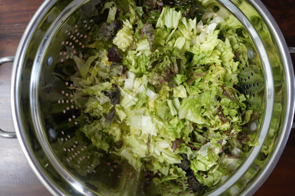 chopped romaine in a strainer 