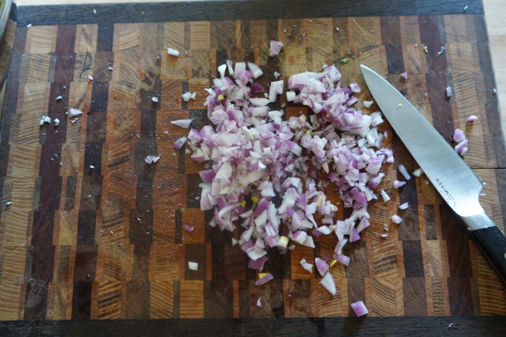 chopped red onion on a cutting board