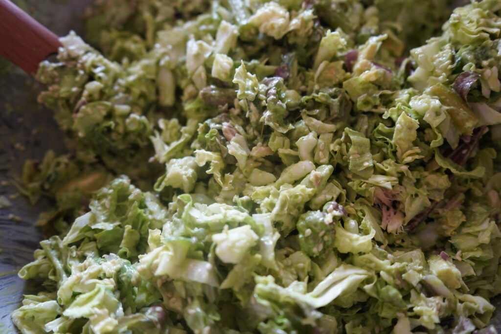 a green salad in a mixing bowl