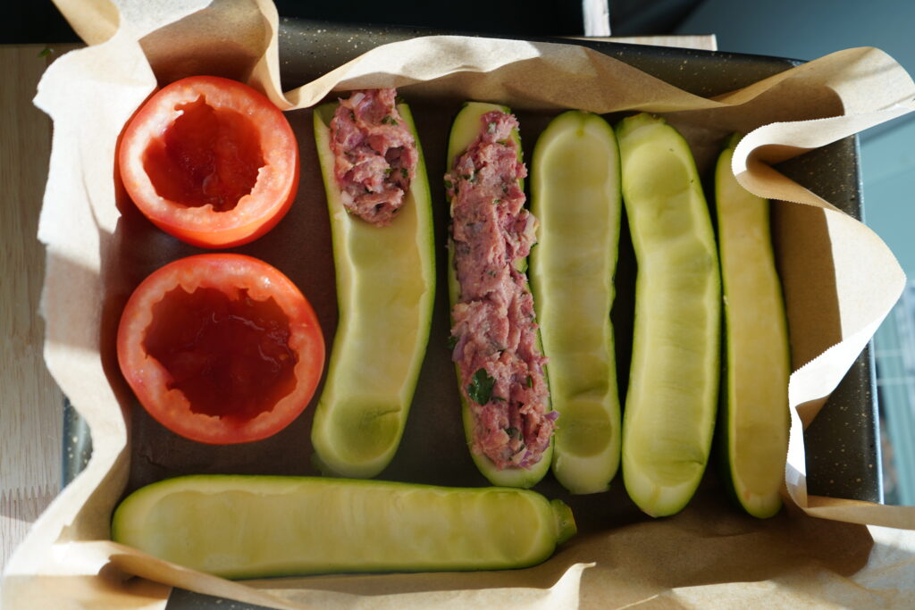 cored vegetables in a parchment paper lined baking tray