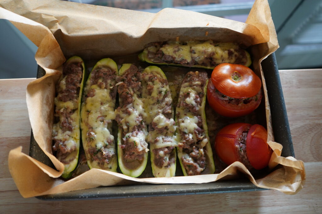 a bunch of vegetabels stuffed with meat topped with cheese