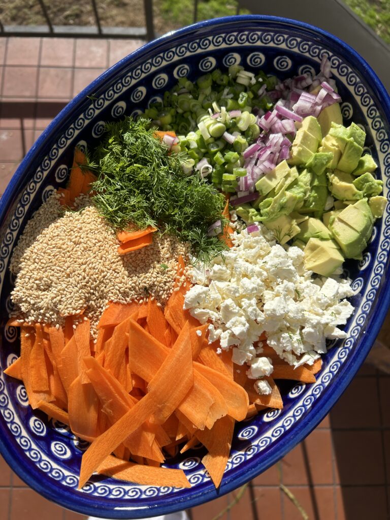 a hormone loving raw carrot salad in a blue bowl