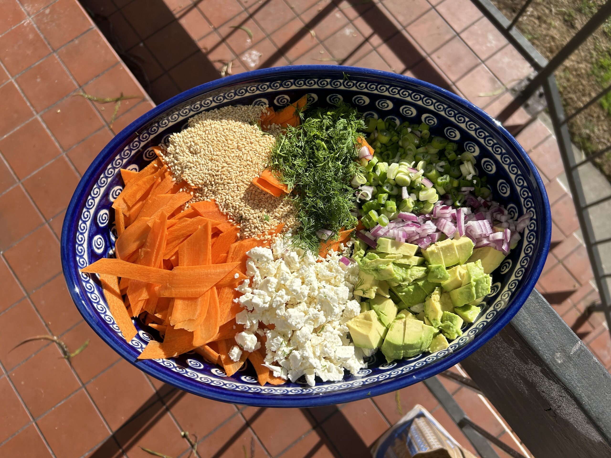 a carrot salad in a blue bowl