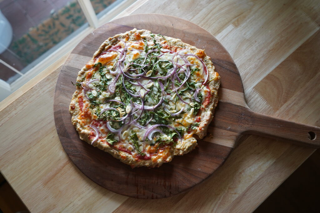 gluten-free high protein pizza on a wooden table