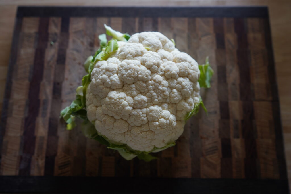 w head of cauliflower on a cutting board