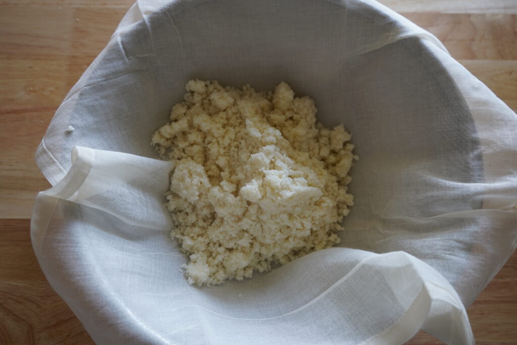 minced cauliflower on a milk cloth over a bowl