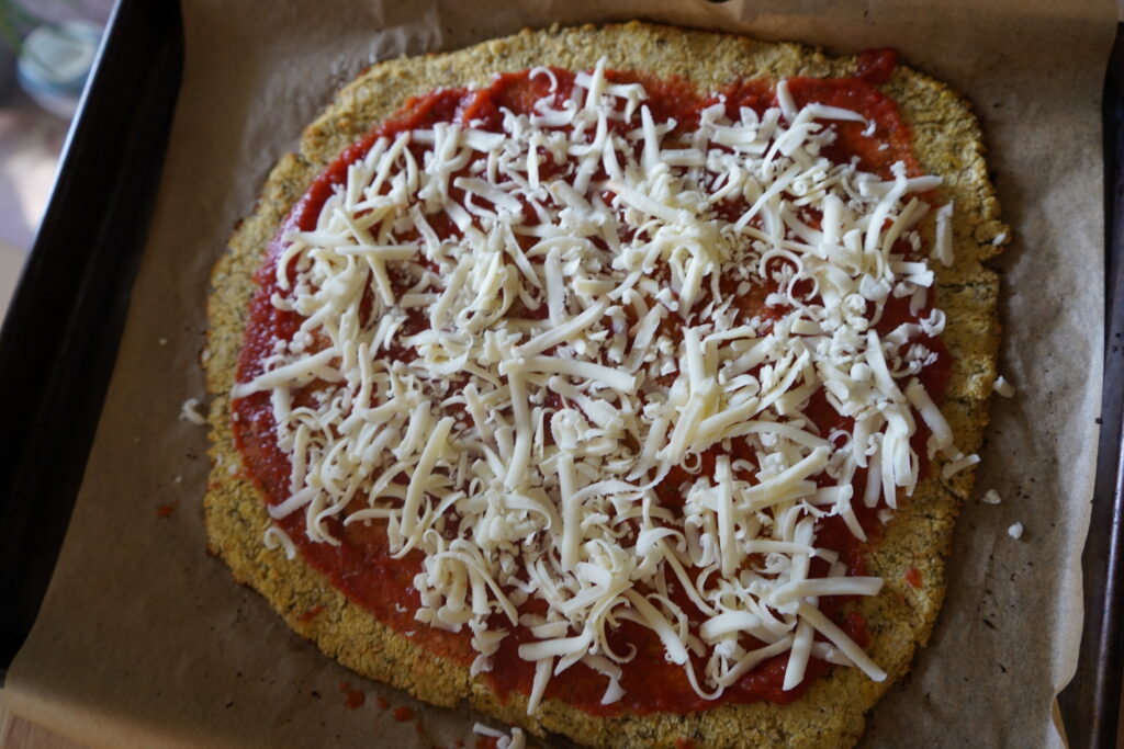 cauliflower crusted pizza on a pan