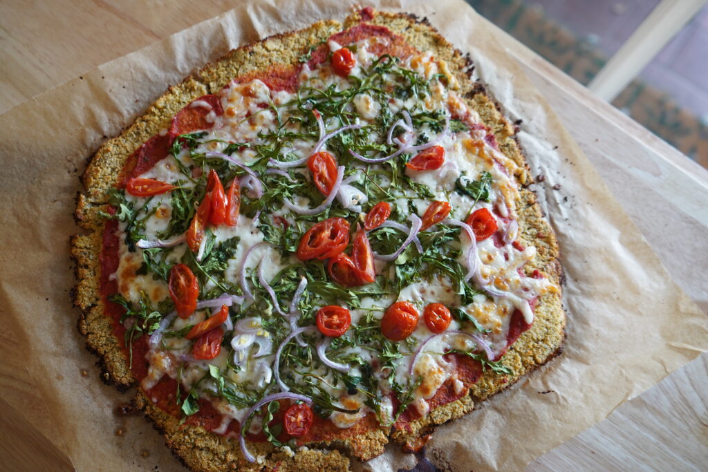 cawliflour pizza crust on a parchment paper