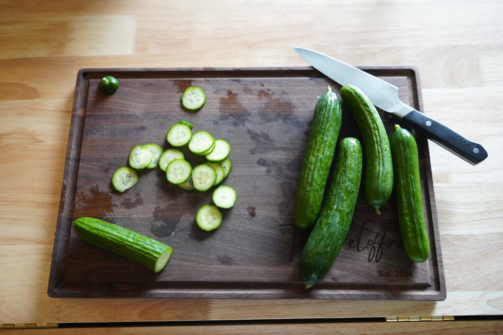 persian cucmbers sliced on a cutting board