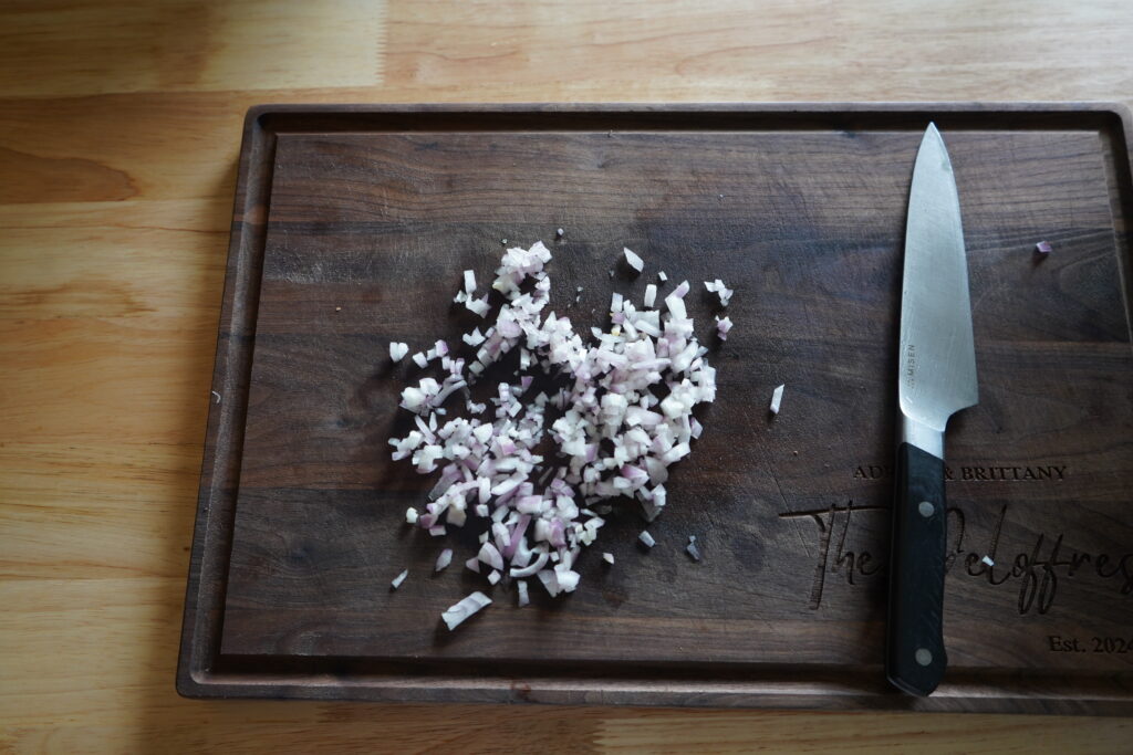 finely chopped shallot on a cutting board