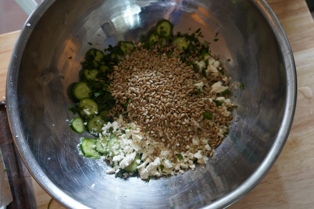 toasted sunflower seeds added to the salad bowl of cucumber
