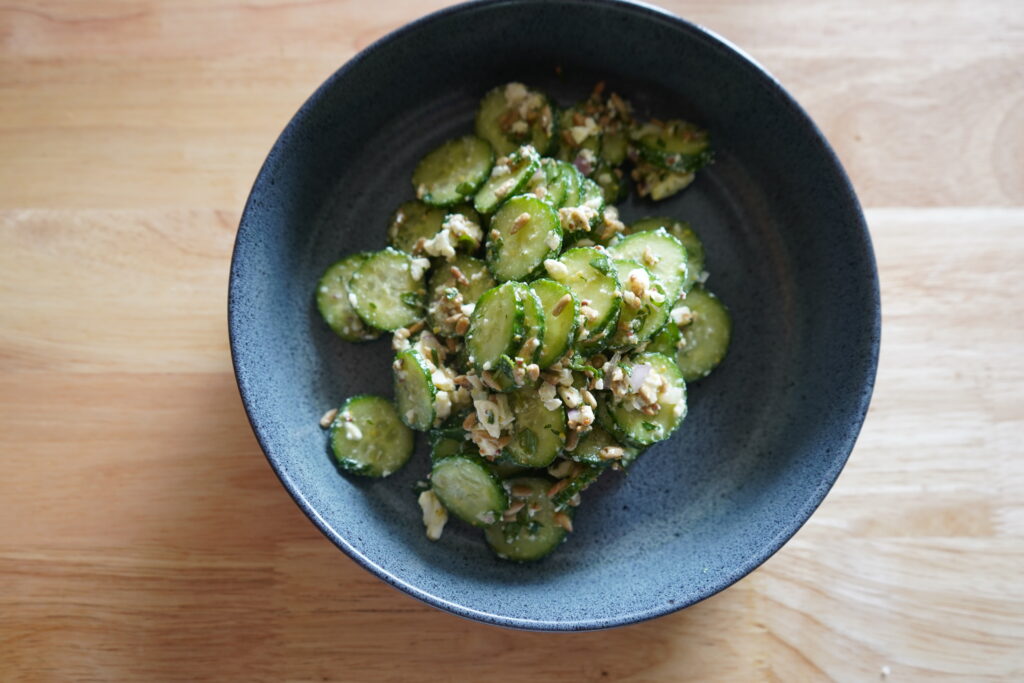 cucumber, feta salad in a blue bowl