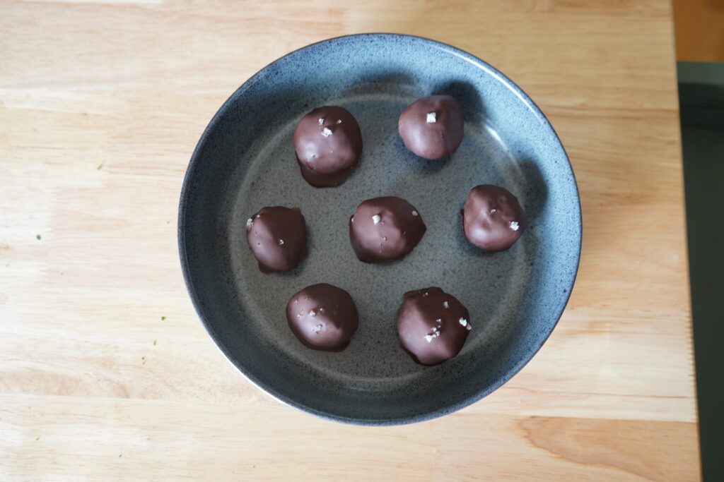 seed cycle friendly date balls in a blue bowl