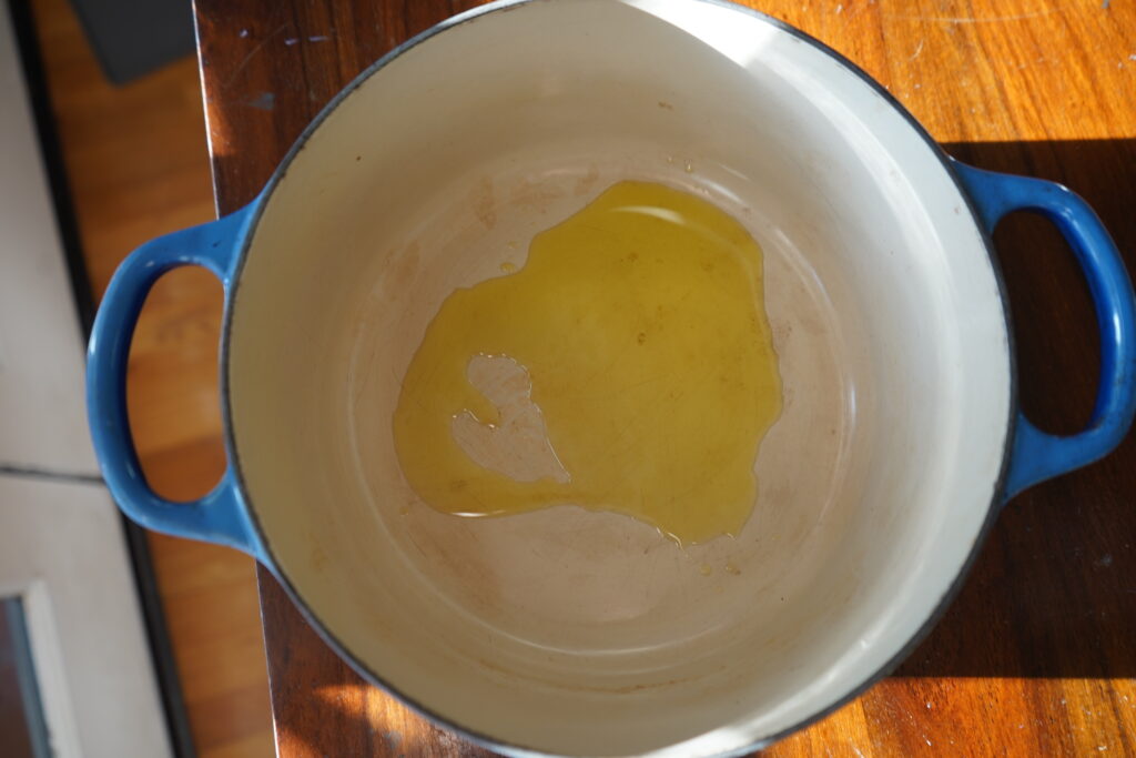 olive oil in a blue dutch oven