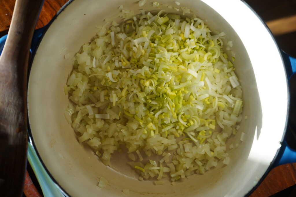 leeks added to chopped onion into a dutch oven