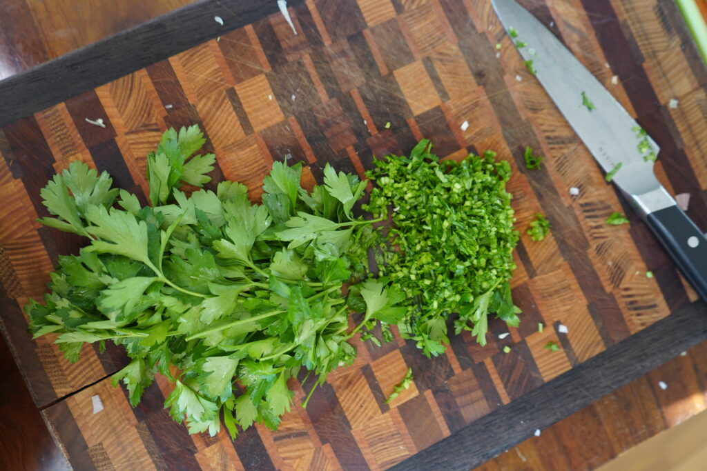 parsley with the stems chopped on a cutting board