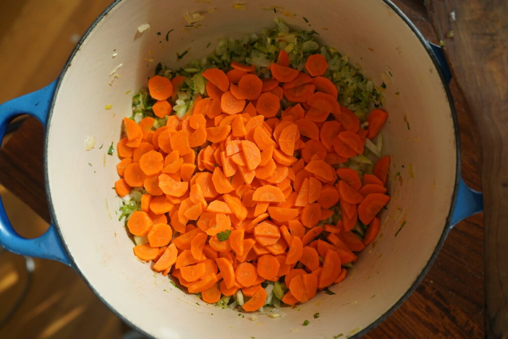 chopped carrots added to a dutch oven