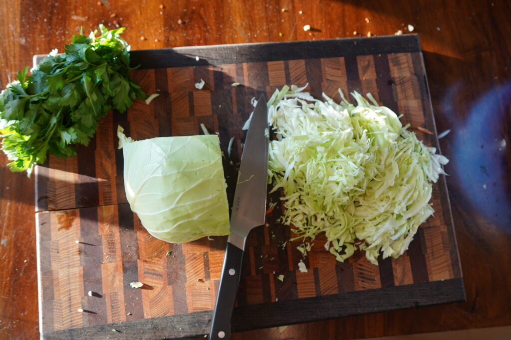 cabbage finely shredded on a cutting board