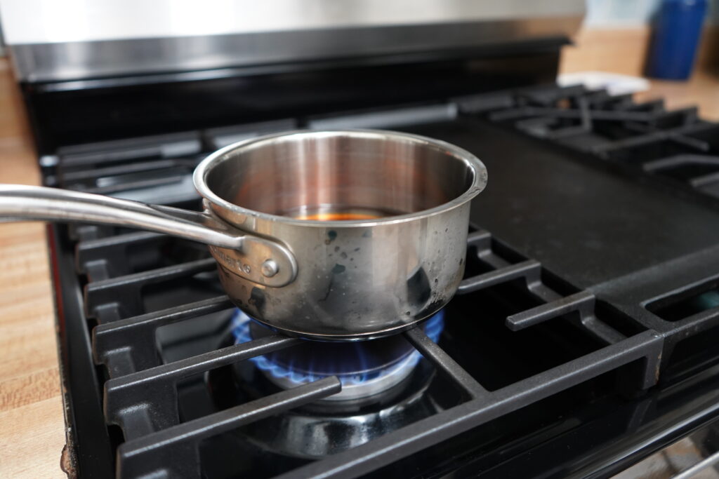 a sauce pan on the stove being heated up