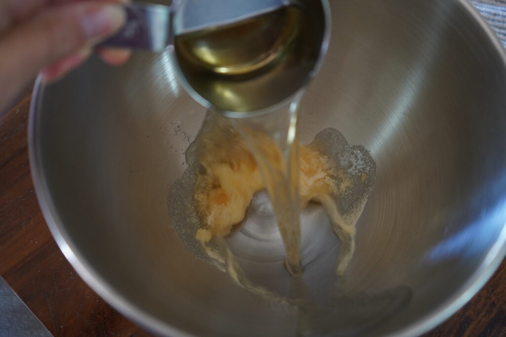 Water being poured into a mixing bowl with gelatin in it