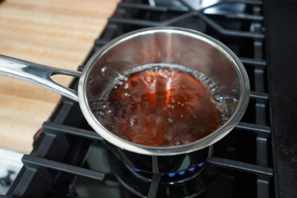 Maple syrup and water boiling on a stove