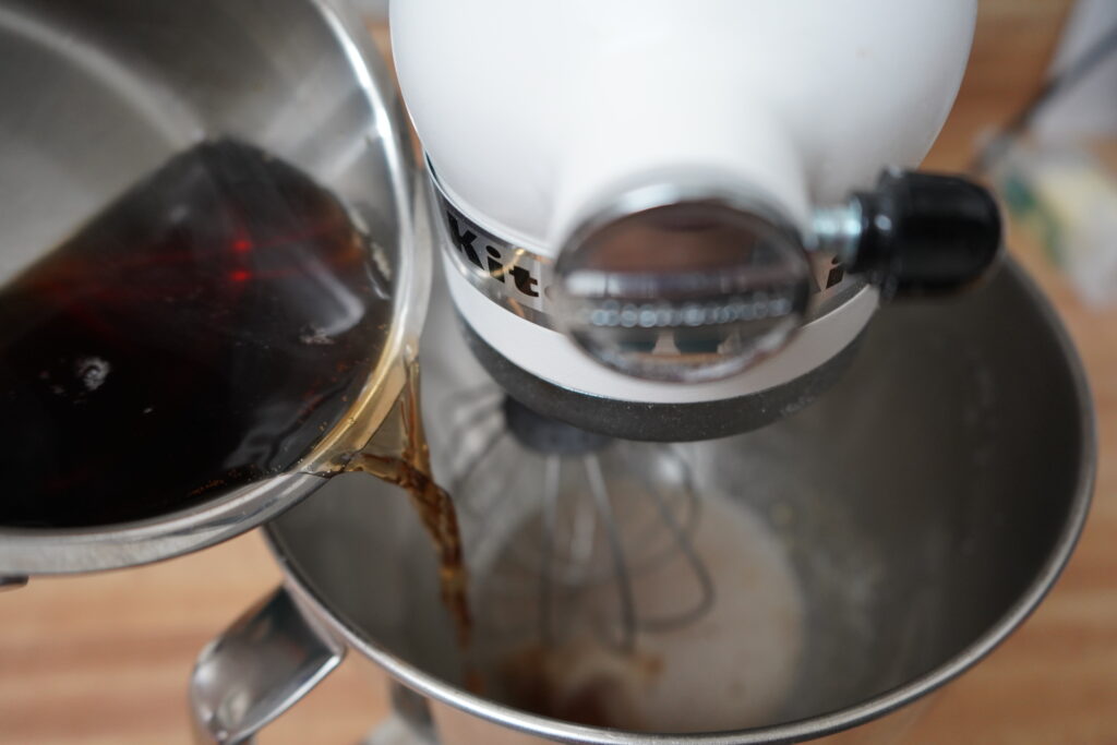 maple syrup being poured into a stand mixer