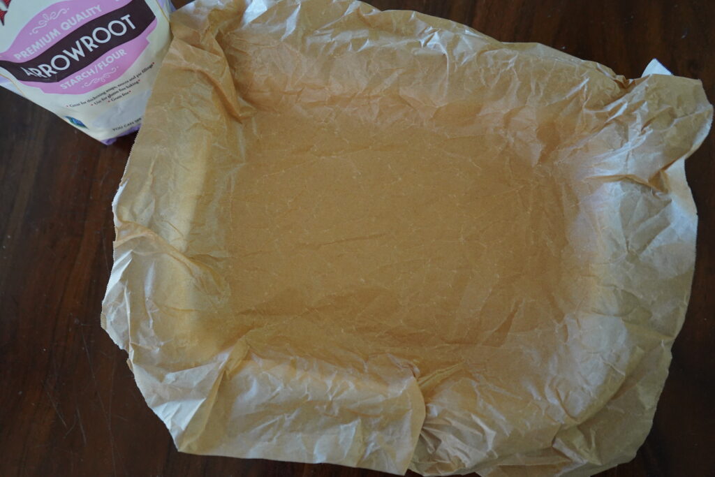 parchment paper linging a baking dish