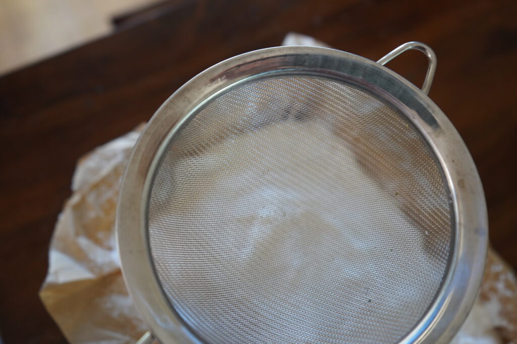 a fine strainer over marshmallows