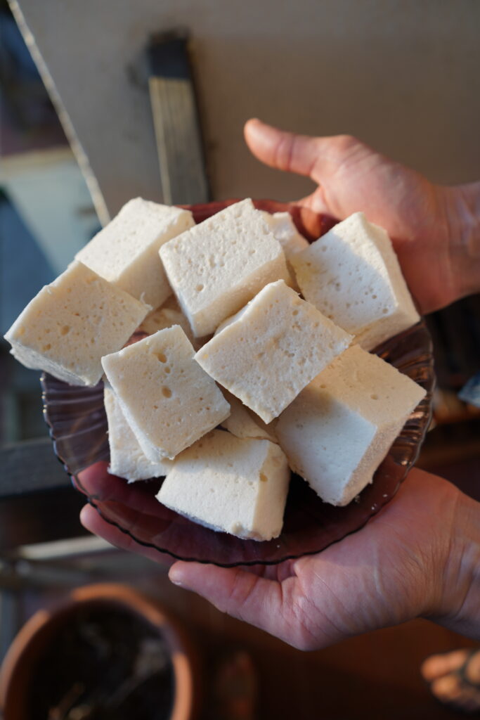 hands holding a bowl of homemade marshmallows