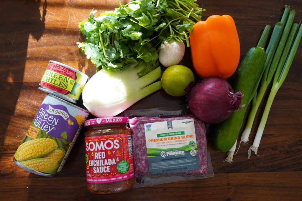 a bunch on enchilada ingredients on a table