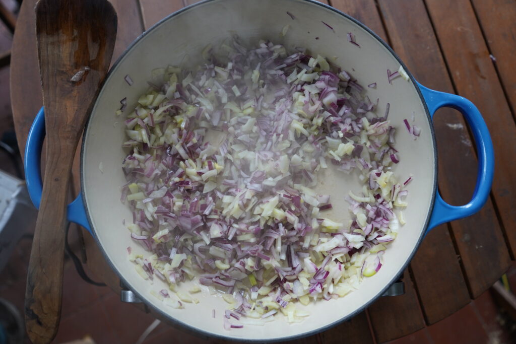 sauteeing vegetables in a pan