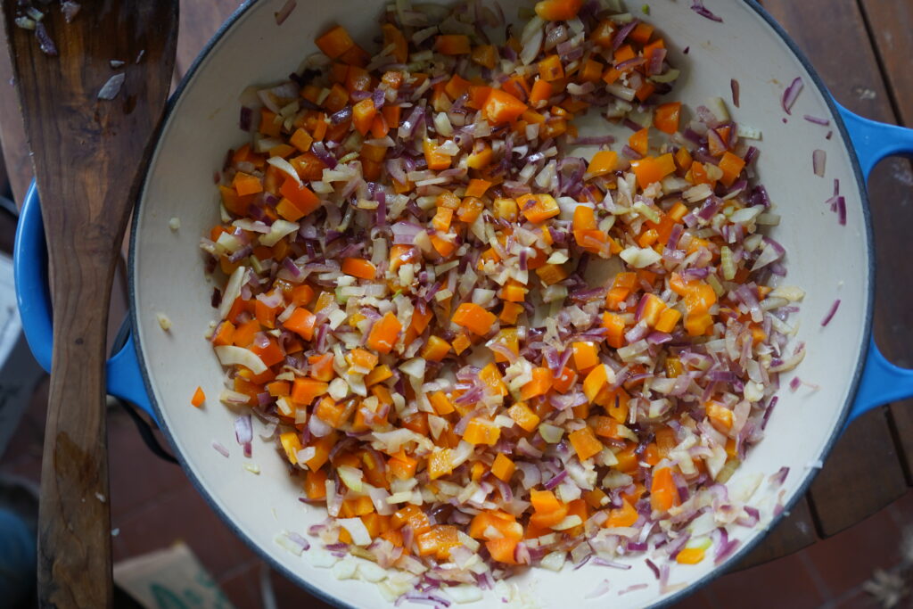vegetables being sauteed in a pan