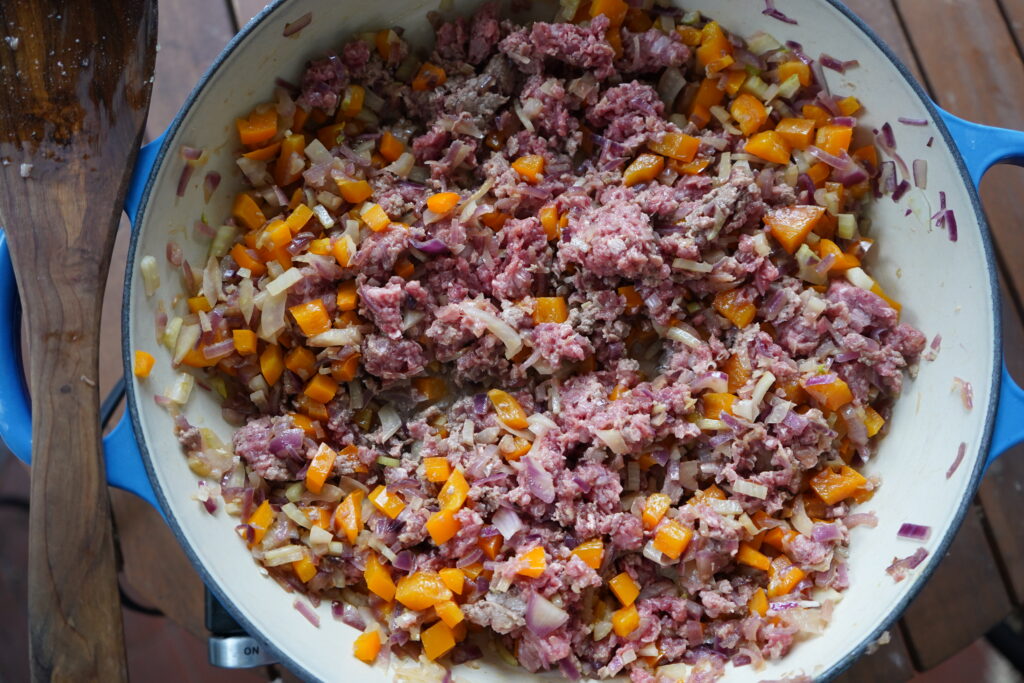 a skillet of ground beef and vegetables
