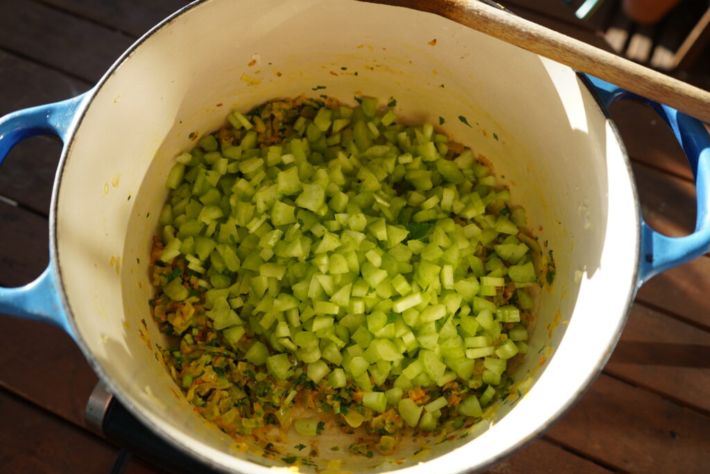 chopped celery added to a dutch oven of sauteed onions 