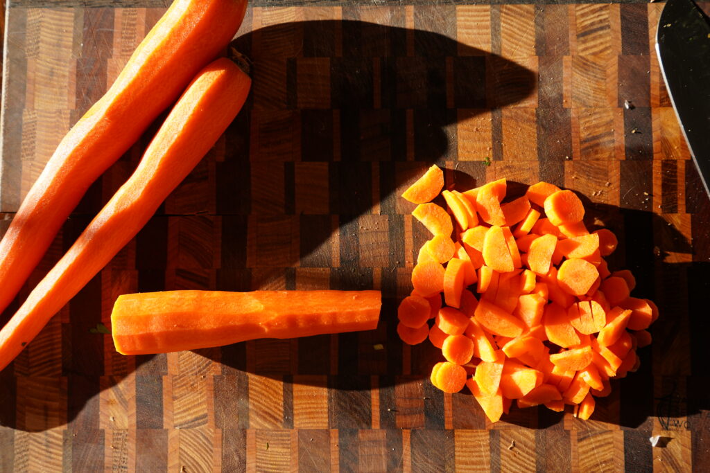 carrots being chopped on a cutting board