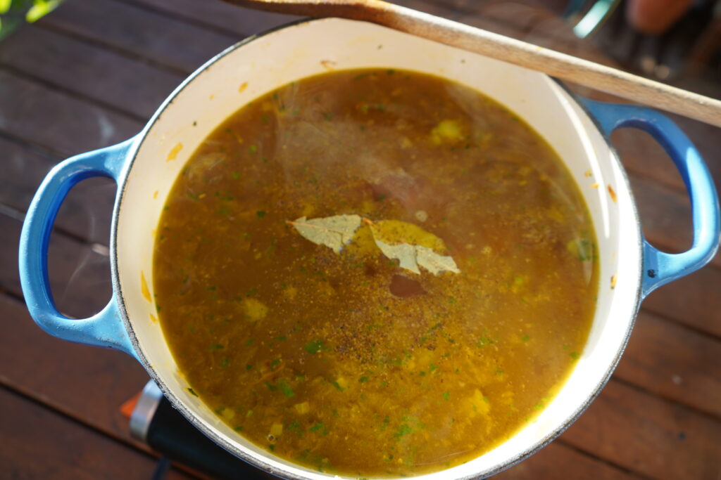 bay leaves added to the top of a pot of soup
